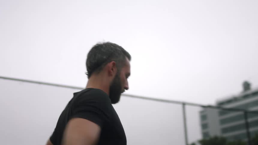 A man is throwing his arms forward and back stretching them