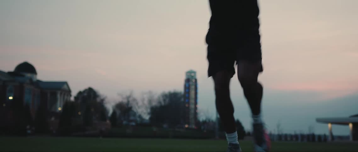 Legs of a person running sideways with soccer warmup movements
