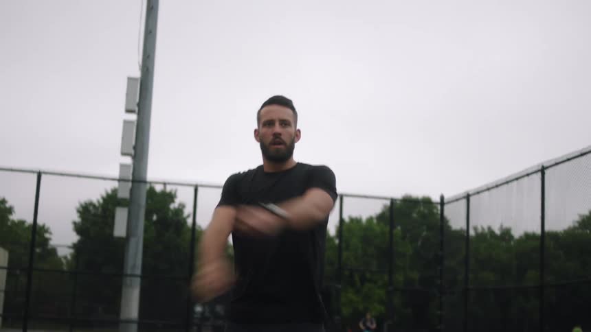 Man walking, moving, and stretching his arms