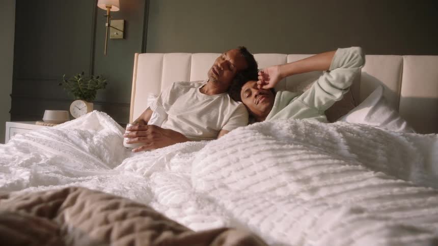 A couple lay in bed together