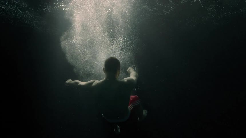 Motionless body of a man falling into the ocean