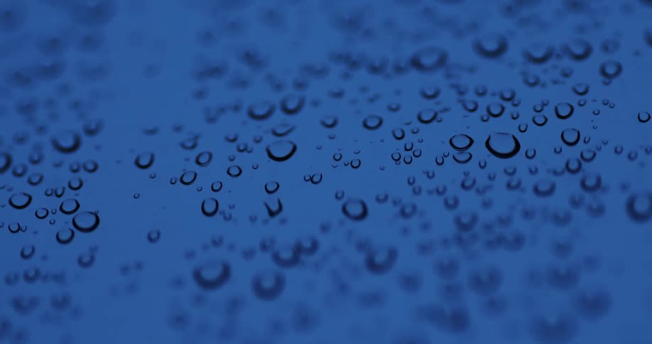 Several transparent bubbles on a light blue surface