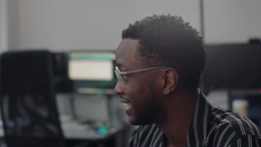 A young man explaining or having a conversation during a meeting in the office