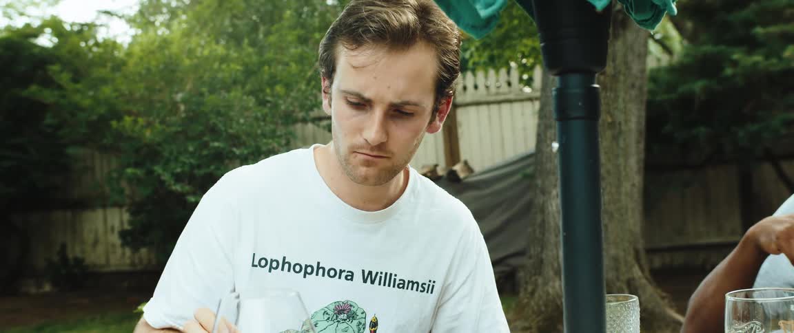 Portrait of a man in the backyard of a house eating