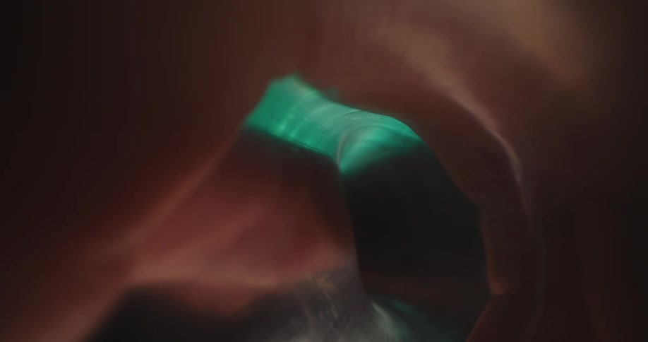 Interior view of a plastic bottle with a hand around it