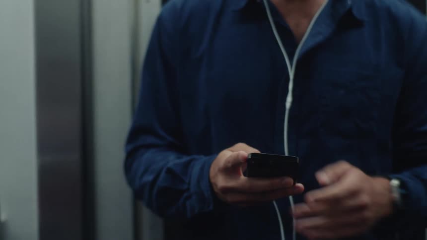 Person using cell phone on a moving train