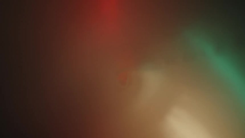 Extreme closeup interior view of a colored cylinder with smoke coming in