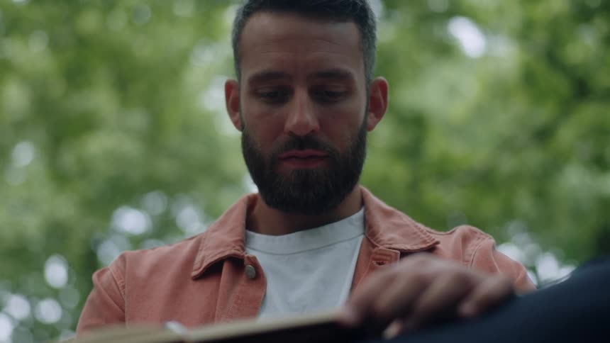 A man is writing in his notebook