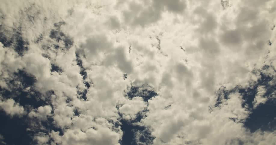 A sky with several white clouds with a little gray and behind there is the blue sky