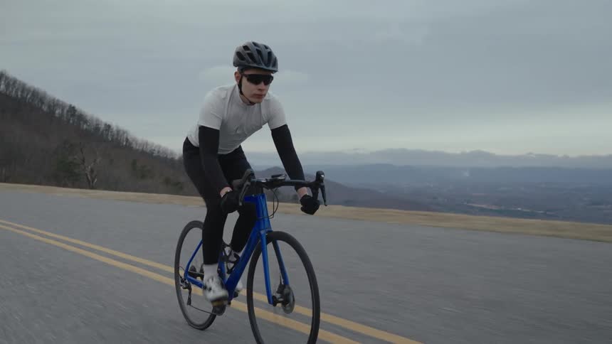 A man is cycling on the road