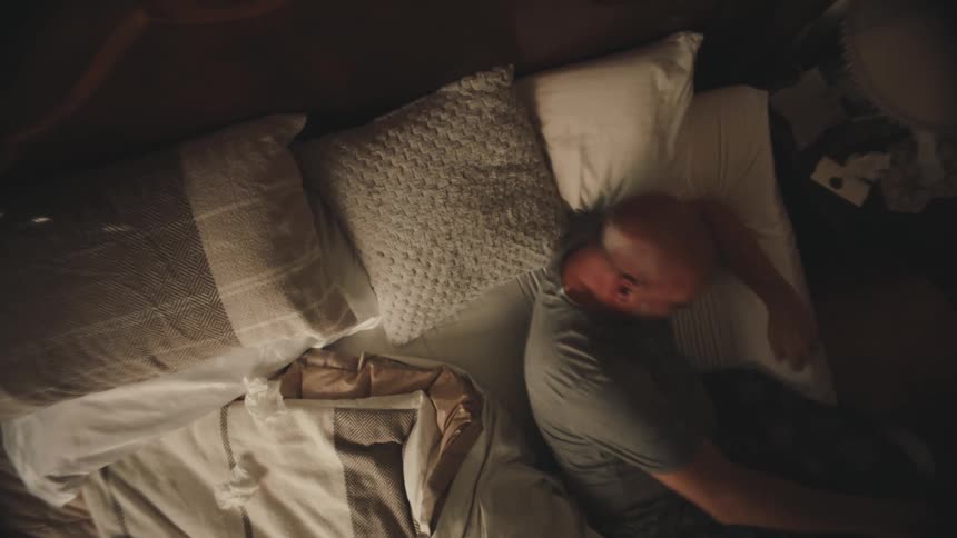 Man getting up from bed