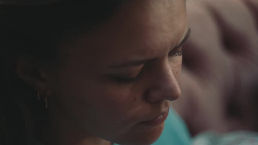Woman frowns while sitting and thinking
