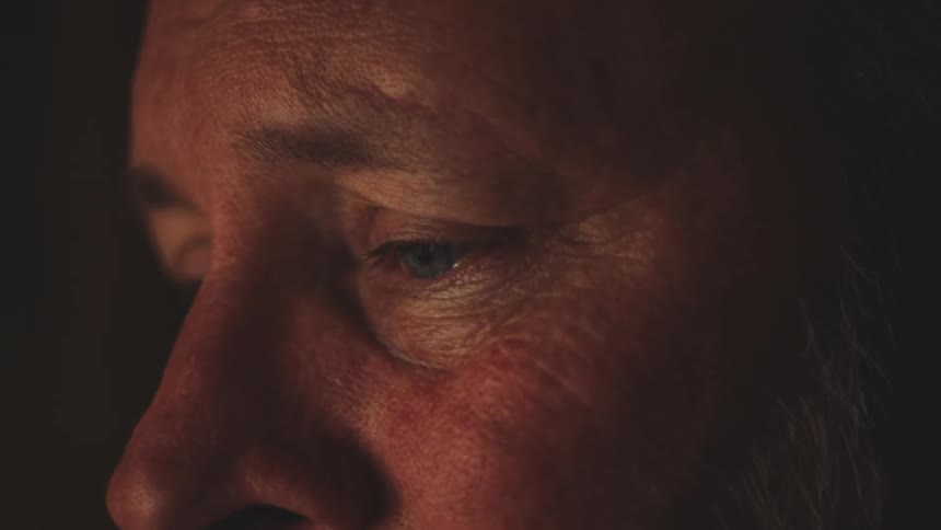 Close up of the sad face of a man at night