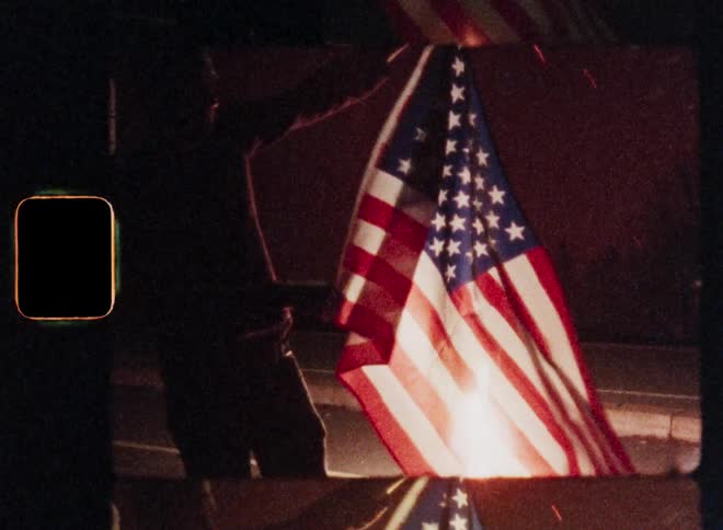 Silhouette of patriotic American person holding the Stars and Stripes flag of the United States in front of exploding fireworks celebrating Independence Day or 4th of July on a street at night being proud of his homeland or fatherland