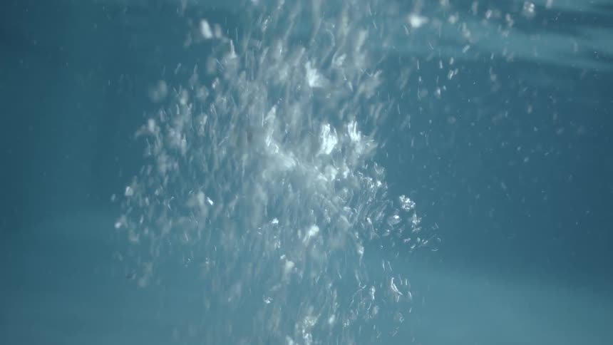 The bubbles float up in the swimming pool