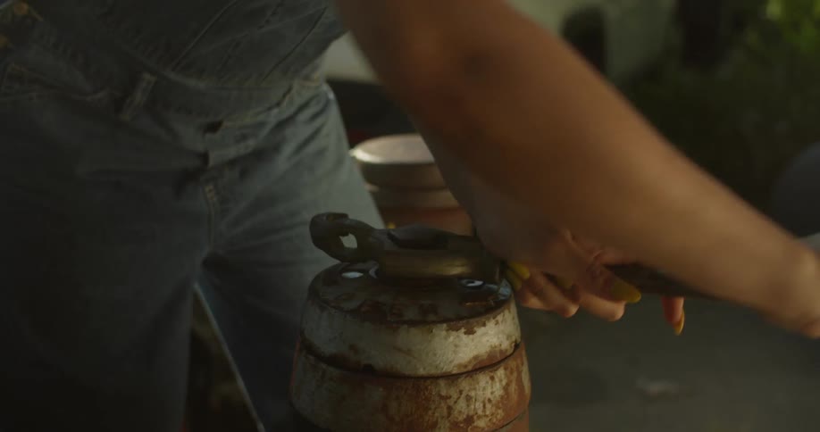 Woman with a wrench opening a water gasket