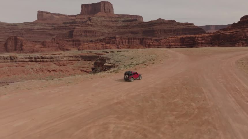 Jeep traveling in a natural environment surrounded by canyons