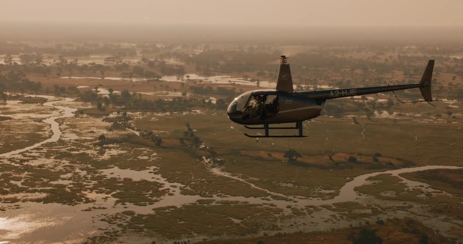 Aerial view of a helicopter flying over the swamps of the Okavango Delta