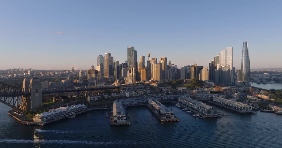Aerial panorama of a metropolis with a skyscraper by the sea and against a blue sky
