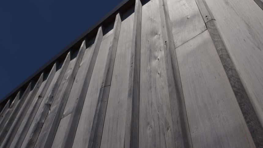 Metallic exterior wall against a blue sky