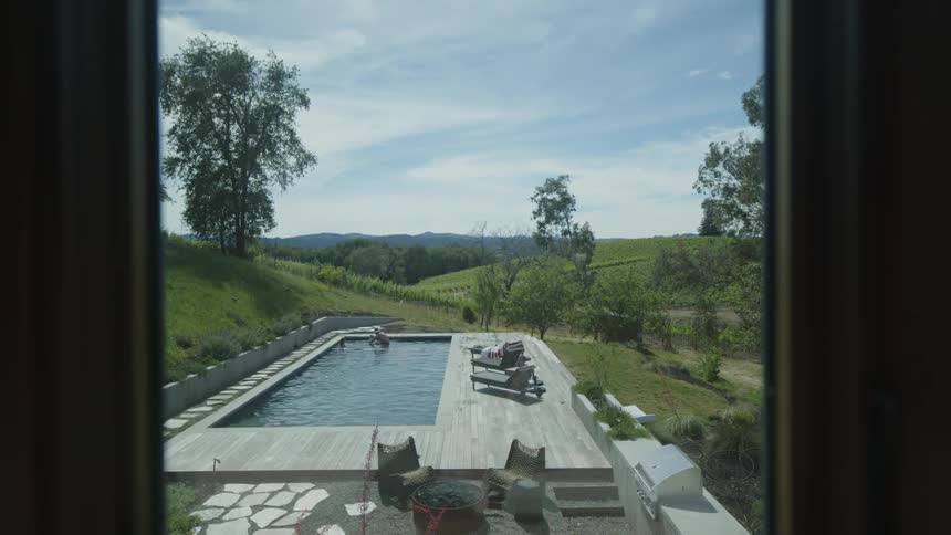 View from the interior window of a swimming pool with two people