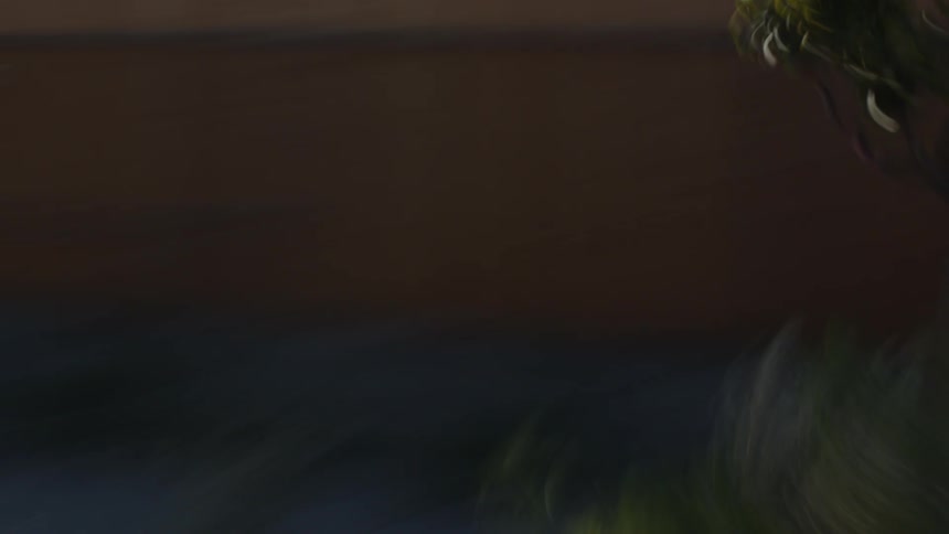 A driving car passes by in a slow motion blur