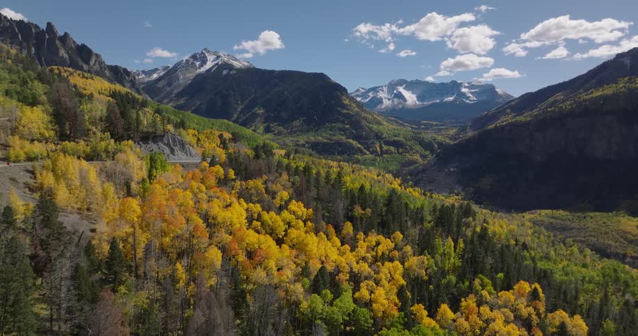 Aerial panorama of mountains with colorful conifers