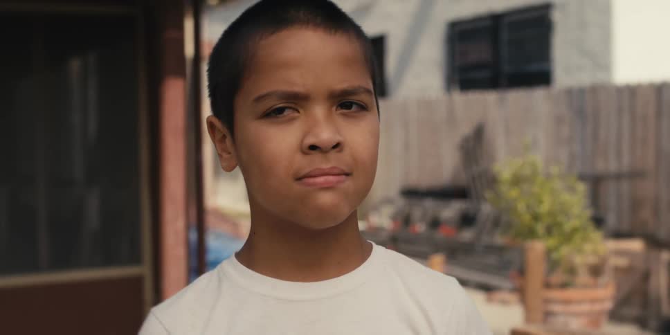 A child is standing in the yard