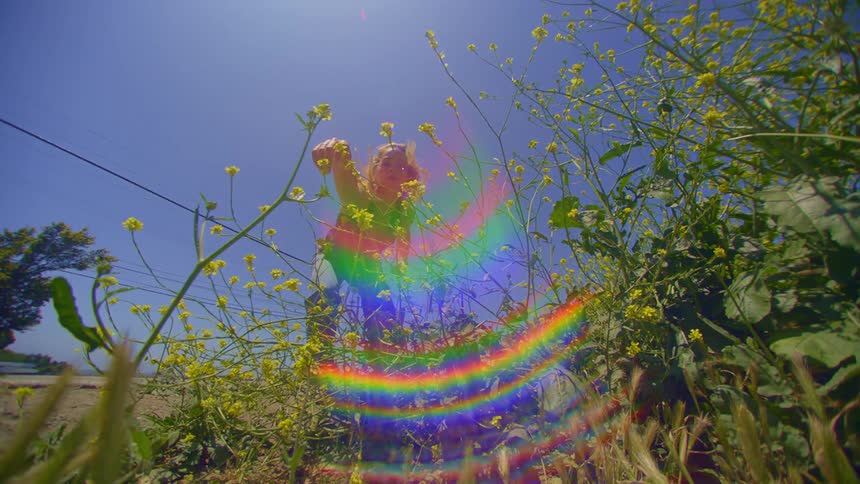 Blonde woman dancing in an environment with green plants around