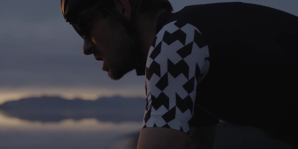 Man riding a bicycle on road at dusk