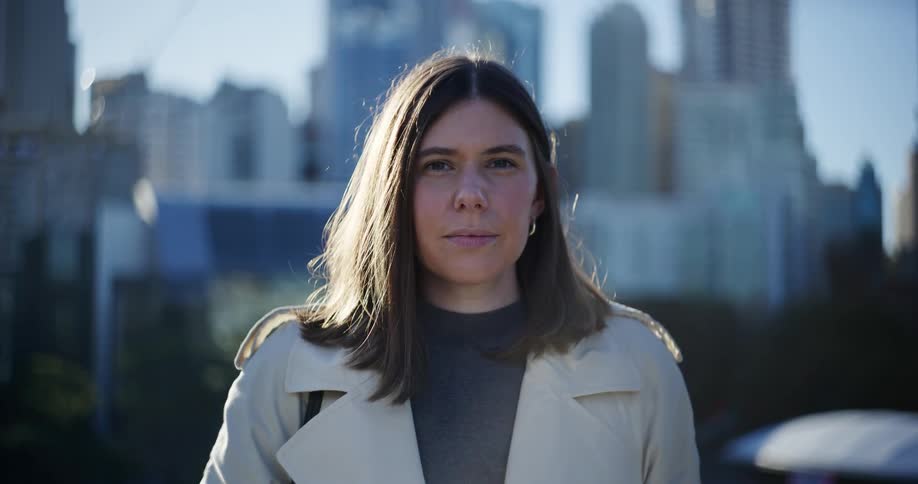 A woman is standing before the city