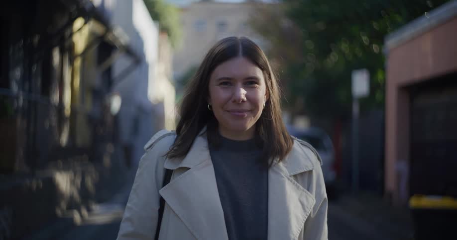 A woman is smiling outside