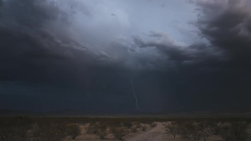 A storm of bright rays in gray clouds in the sky