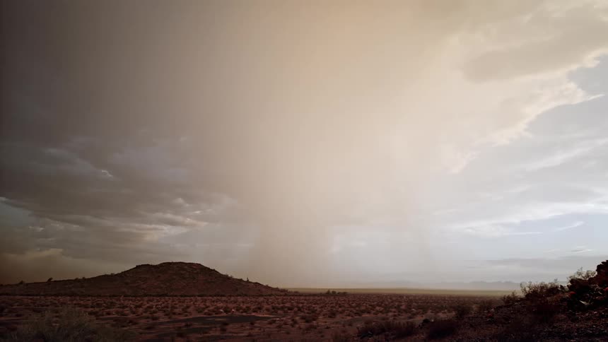 Mountain scenery in a dry vegetation location against a dark sky with storm and thunder