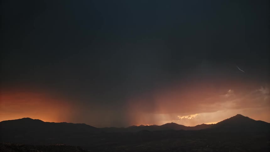 A dramatic thunderstorm with lightning strikes against a dusky sky