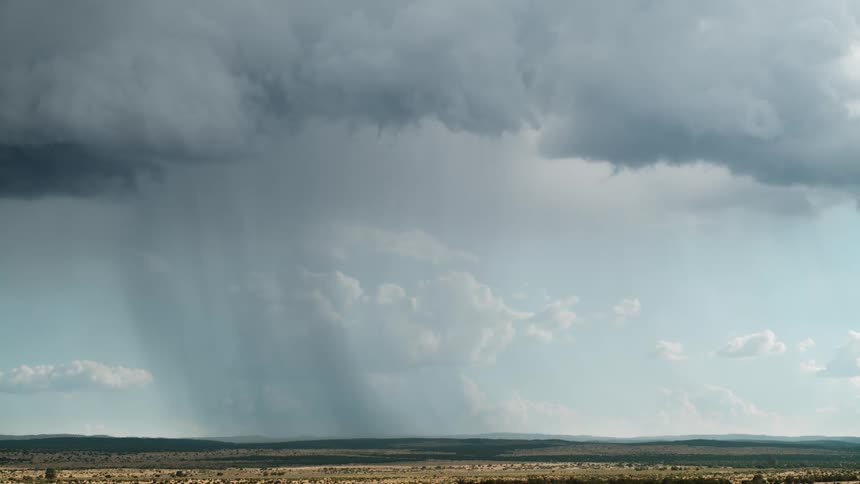 A dramatic thunderstorm with lightning strikes the plains in daylight