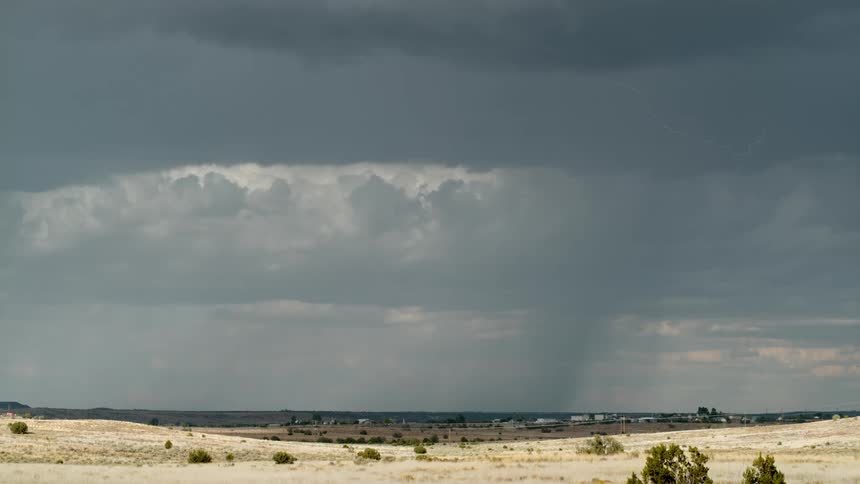 Heavy rain and lightning pour on the landscape