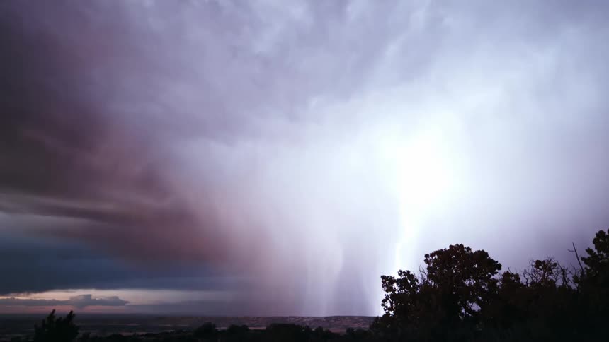 A dramatic thunderstorm with lightning strikes against a dusky sky