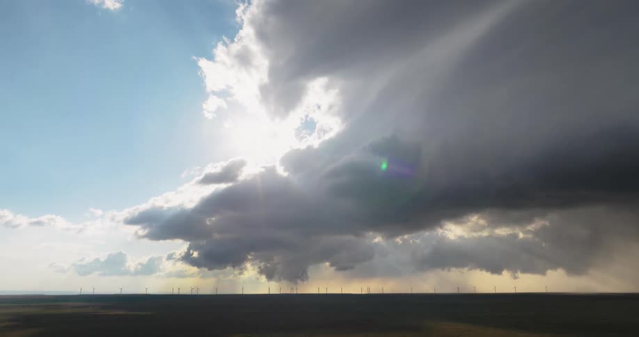 Intense clouds above a greenish field