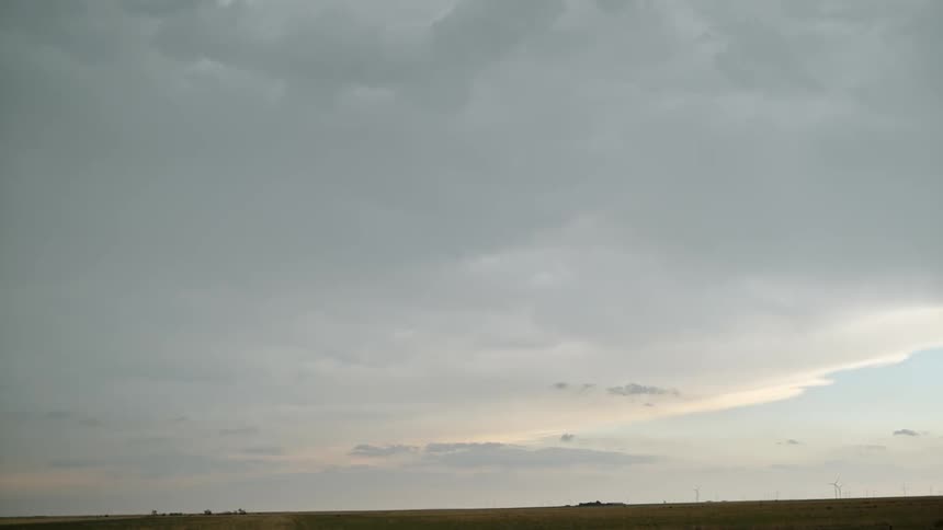 A bright lightning bolt striking down from a cloudy sky