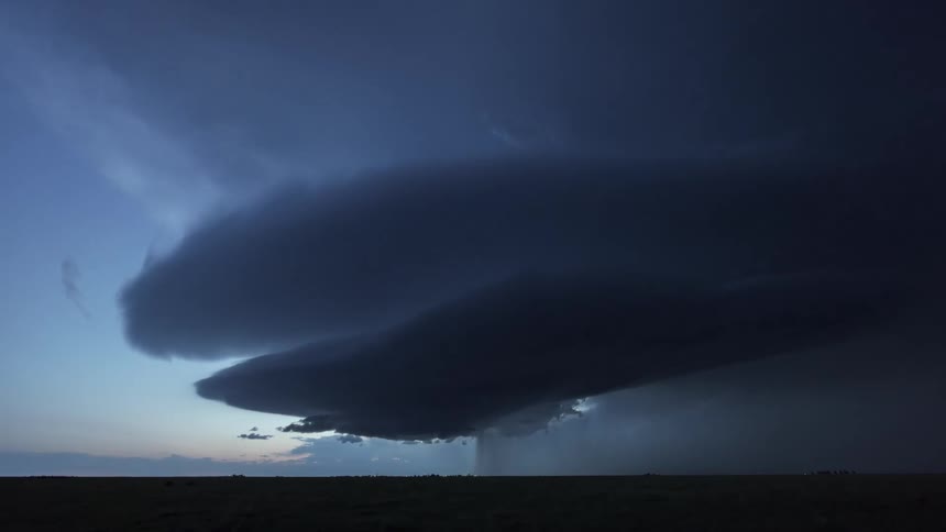 Scenery of a natural grass field and a sky with storm and thunder
