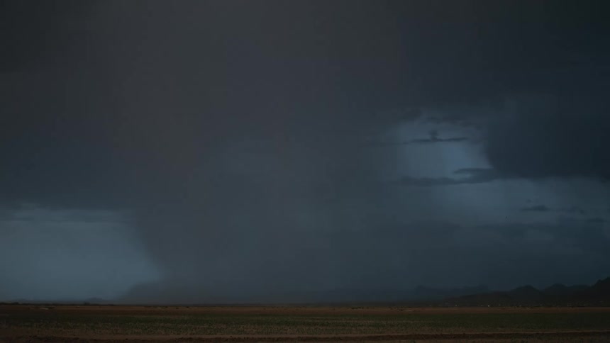 A dramatic thunderstorm with lightning strikes against a dusky sky