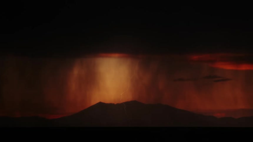 Lightning flashes over the mountain just after the sun has set