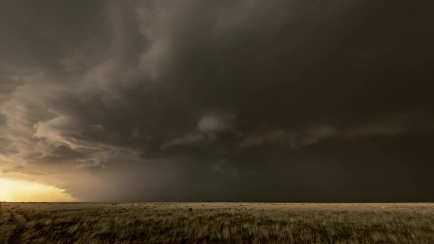 Black storm above a field