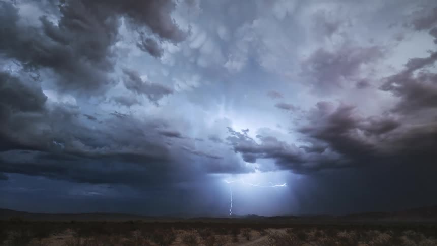 Lightning strikes the ground in arid scrub land during a lightning storm
