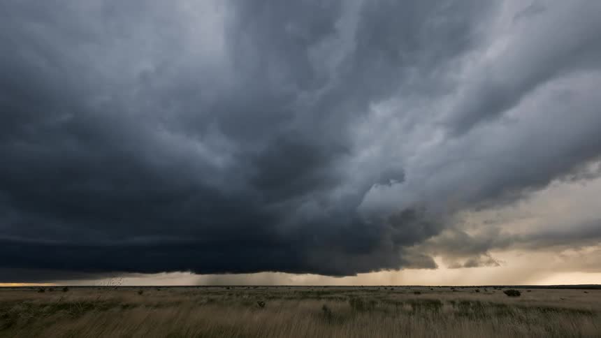 Landscape of a field and a strong storm