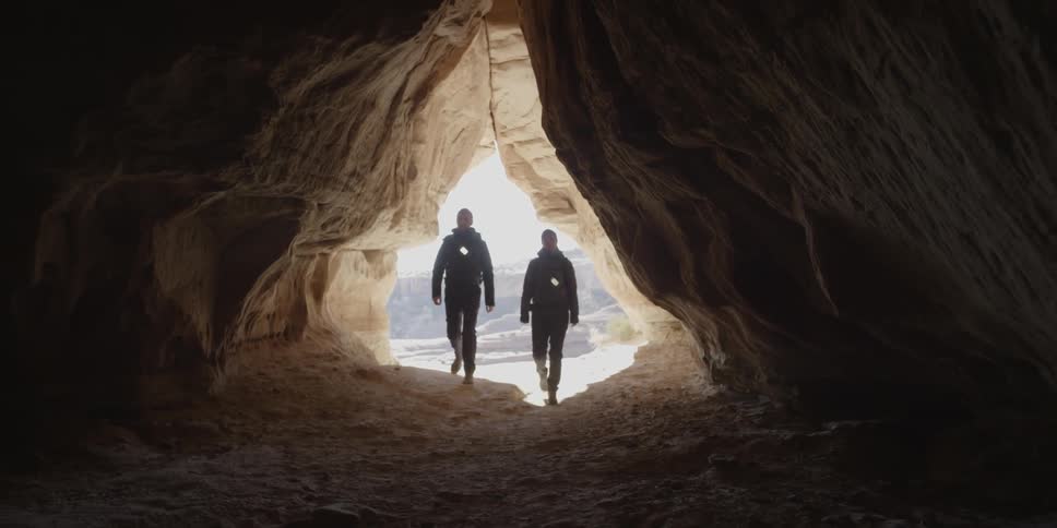 Two people walk into a cave