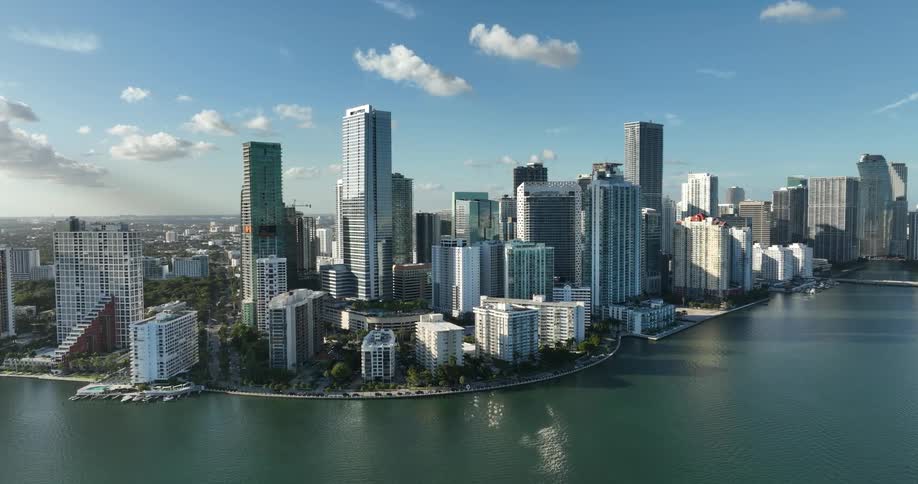 Midrise buildings on the edge of downtown follow the curve of the waterfront on a cloudy day