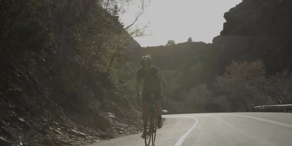 A man rides a bicycle up a hill