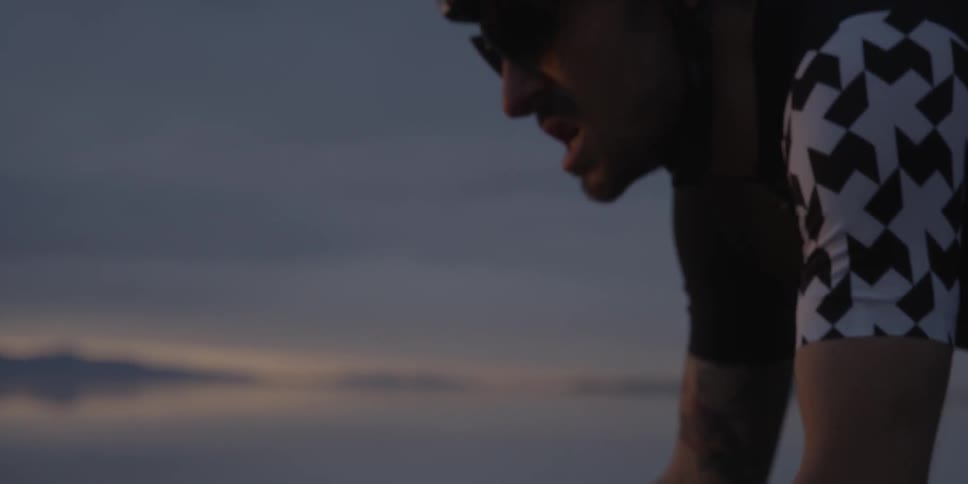 Close up of a cyclist pedaling on a cloudy evening